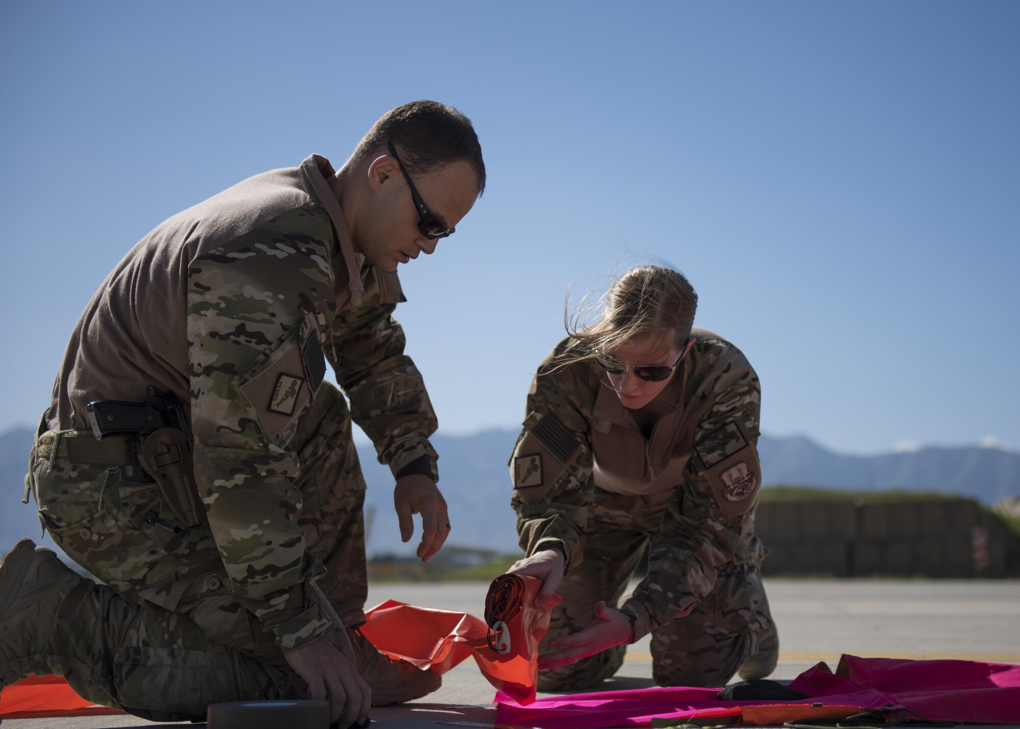 Pararescuemen from the 83rd Expeditionary Rescue Squadron lay down panels as other team members ready themselves to jump from a C-130J Super Hercules during a mission rehersal at Bagram Airfield, Afghanistan, April 28, 2016. Members of the 83rd Expeditionary Rescue Squadron are aided by the 774th Expeditionary Rescue Squadron as they conduct a mission rehersal to stay up to date on their training and tactics in support of Operation Freedom's Sentinel and NATO's Resolute Support Mission. (U.S. Air Force photo by Technical Sgt. Robert Cloys)