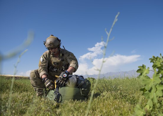 A pararescueman from the 83rd Expeditionary Rescue Squadron packs in his parachute after a jump from a C-130J Super Hercules during a mission rehersal at Bagram Airfield, Afghanistan, April 28, 2016. Members of the 83rd Expeditionary Rescue Squadron are aided by the 774th Expeditionary Airlift Squadron as they conduct a mission rehersal to stay up to date on their training and tactics in support of Operation Freedom's Sentinel and NATO's Resolute Support Mission. (U.S. Air Force photo by Technical Sgt. Robert Cloys)