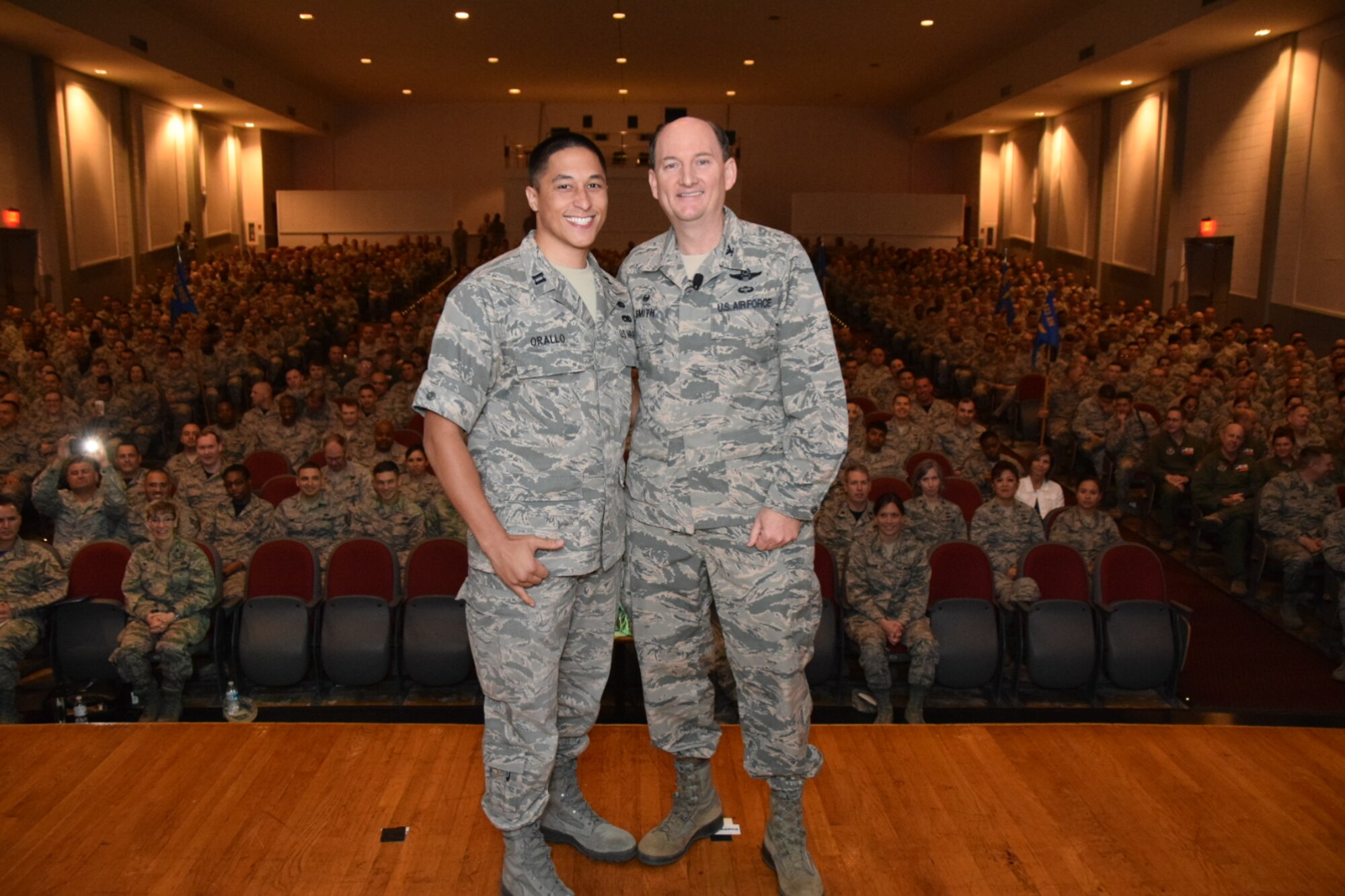 Col. Thomas K. Smith Jr., 433rd Airlift Wing commander, right, congratulates Capt. Robert Orallo III, of the 433rd Logistics Readiness Squadron, on being named the 2015 Air Force Reserve Command Logistics Readiness Squadron Company Grade Officer of the Year during the 433rd AW commander's call April 3, 2016 at the Bob Hope Theater, Joint Base San Antonio-Lackland. (U.S. Air Force photo by Tech. Sgt. Carlos J. Trevino)  