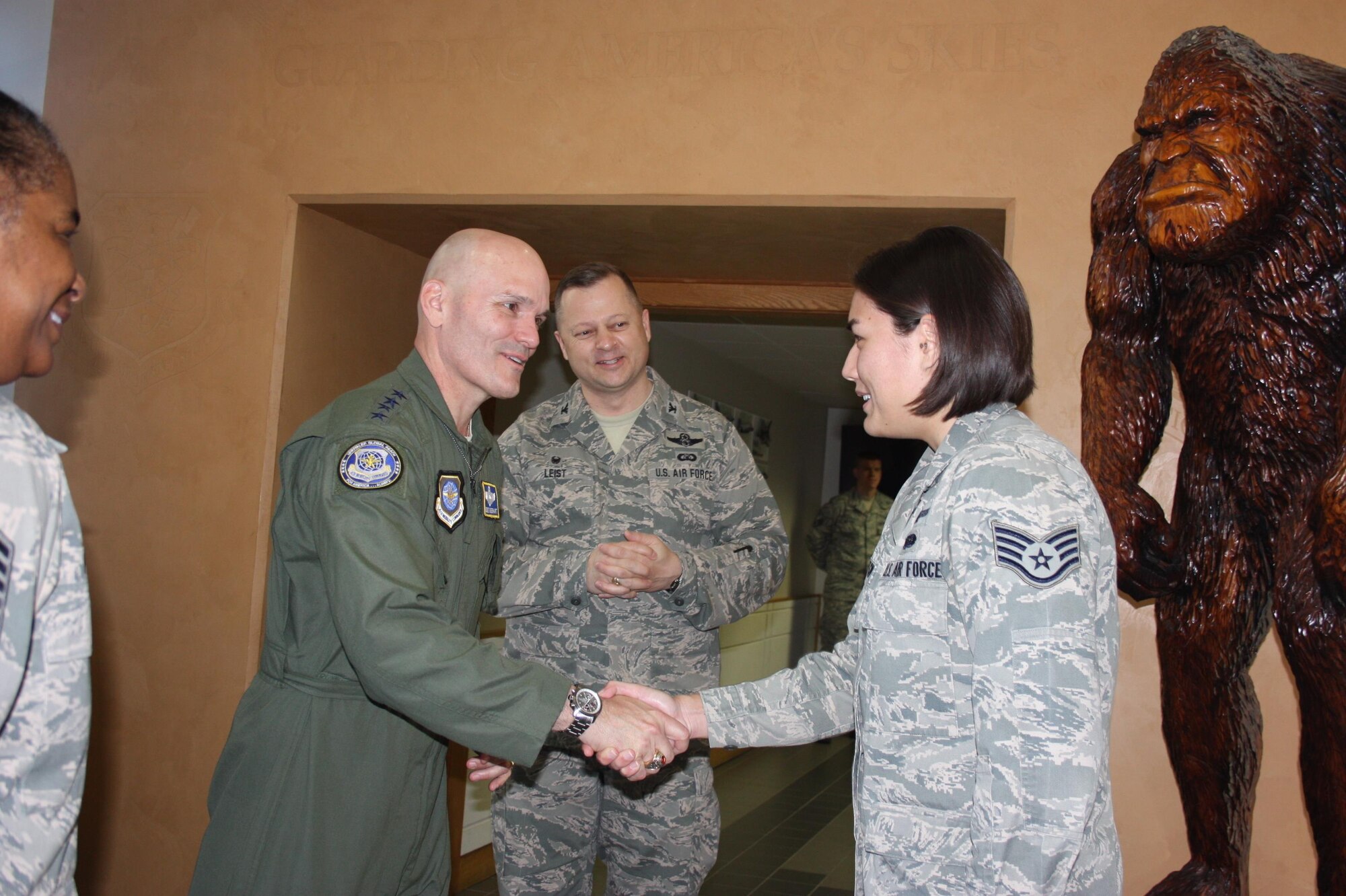 Gen. Carlton D. Everhart II, left, Air Mobility Command commander, presents Staff Sgt. Elisa Layton with a commander's coin for being a Western Air Defense Sector (WADS) Star Performer.  Layton is a RF Transmission Systems apprentice who recently graduated from technical school at Keesler AFB as a distinguish graduate.  She was awarded the "Top Graduate" in IT fundamentals with a 99% test average and recently received her Space Systems Technology Community College of the Air Force degree.
