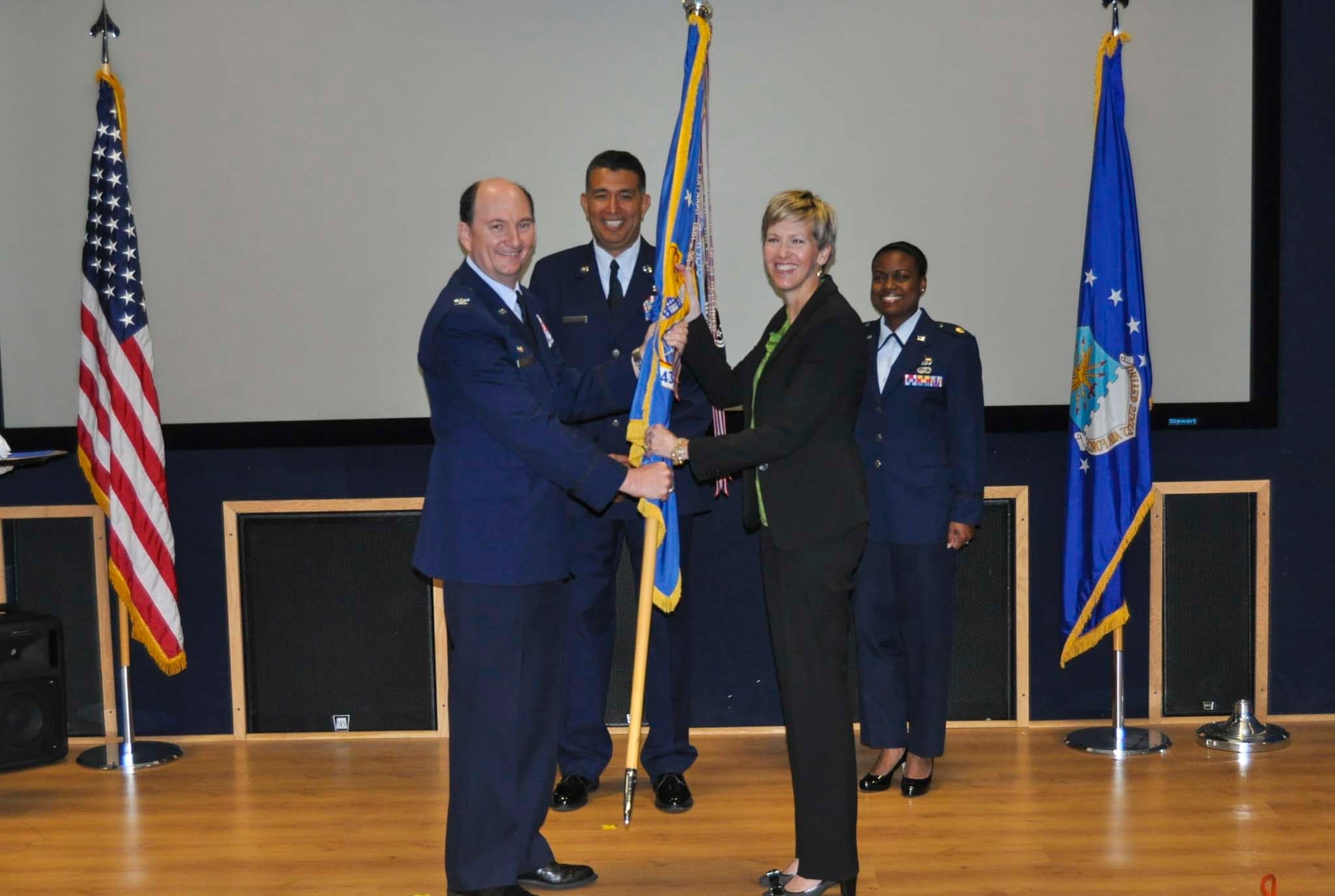 Kelly Lerch accepts the 433rd Airlift Wing guidon from Col. Thomas K. Smith, Jr., 433rd AW commander, during the Honorary Commanders Induction Ceremony held at Joint Base San Antonio-Lackland April 30, 2016. Lerch is the group talent acquisition manager for Enterprise Holdings of South Texas and will be serving as the 433rd Force Support Squadron Honorary Commander.  (U.S. Air Force photo/Senior Airman Bryan Swink)