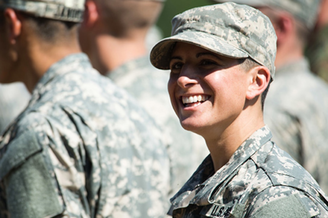 Capt. Kristen Griest smiles at friends and family as she waits with her U.S. Army Ranger School Class to graduate at Fort Benning, Ga., Aug. 21, 2015. Griest and class member 1st Lt. Shaye Haver became the first female graduates of the school. Army photo by Staff Sgt. Steve Cortez