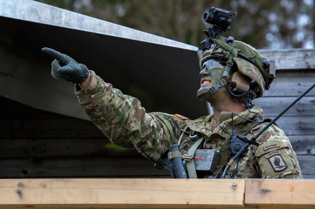 A soldier indicates the location of in-bound helicopters while participating in exercise Saber Junction 16 in Grafenwoehr, Germany, April 18, 2016. The soldier is assigned to the 503rd Infantry Regiment, 173rd Airborne Brigade. The Saber Junction 16 exercise includes nearly 5,000 participants from 16 NATO and European partner nations. Army photo by Pfc. Randy Wren