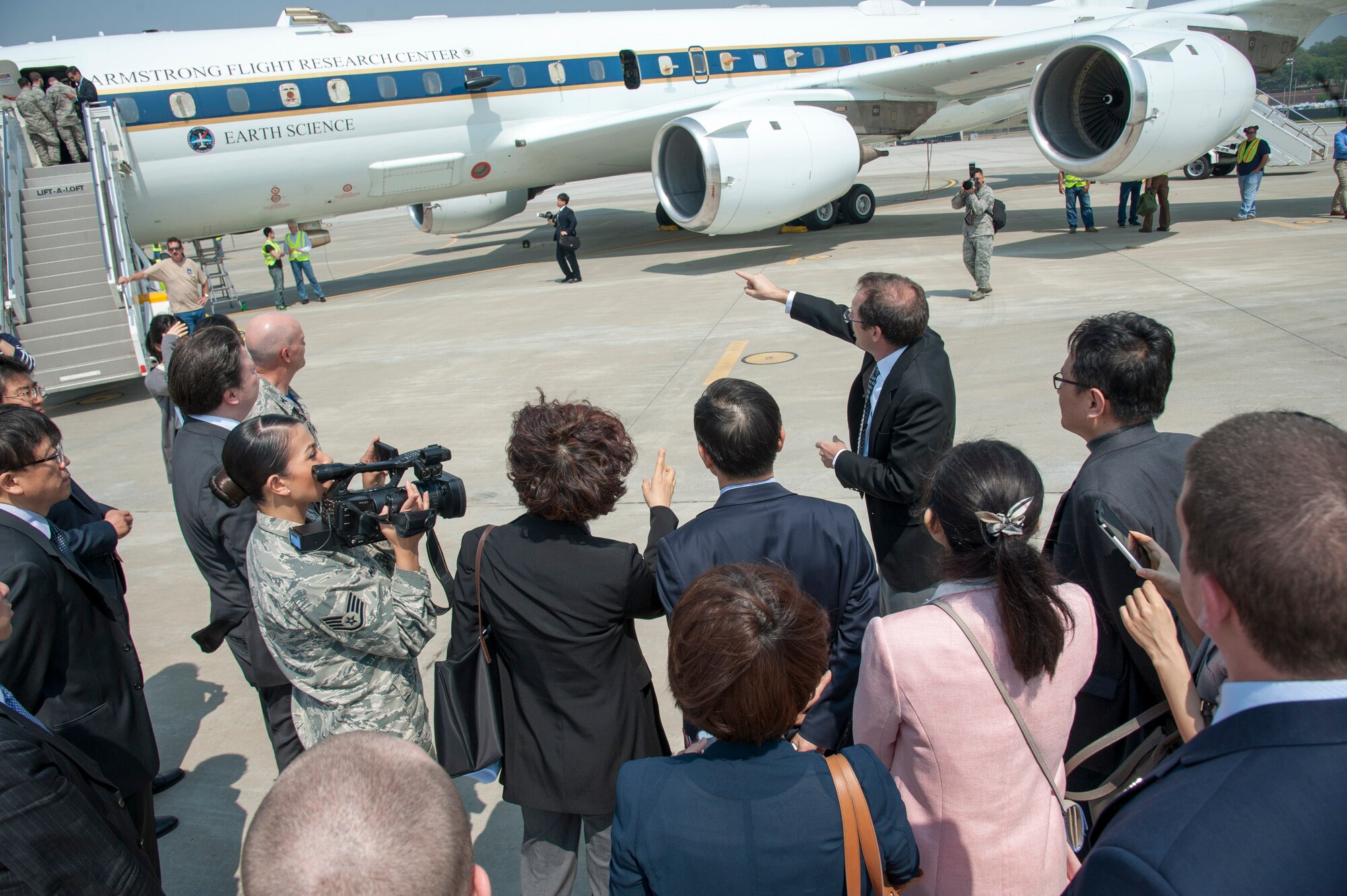 James Crawford, NASA lead U.S. scientist for Korea United States-Air Quality (KORUS-AQ) Experiment, points out the NASA DC-8 jet that will be participating on the Korea United States-Air Quality (KORUS-AQ) Experiment at Osan Air Base, Republic of Korea, April 29, 2016.  KORUS-AQ will collect air quality data over the Republic of Korea using aircraft, ground sites and ships from May 2 until June 12. The U.S. and South Korean aircraft will conduct coordinated flights from Osan Air Base. (U.S. Air Force photo by Staff Sgt. Jonathan Steffen/Released)