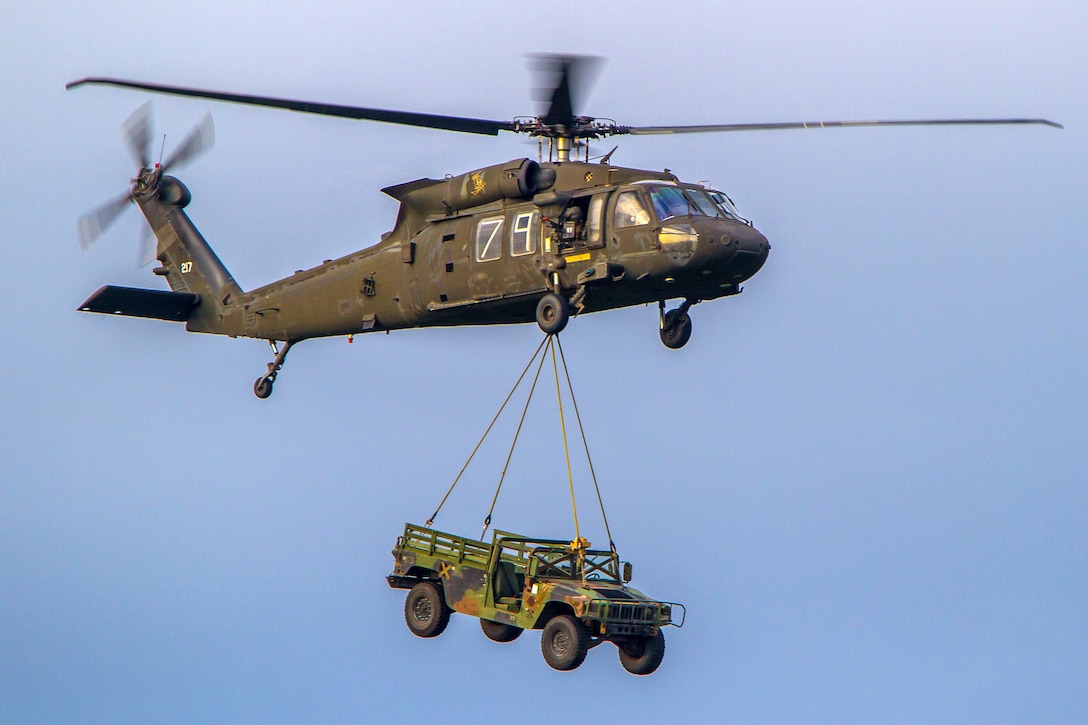 An Army UH-60 Black Hawk helicopter transports a Humvee via slingload during air assault training at Joint Base Lewis-McChord, Wash., April 27, 2016. Army photo by Capt. Brian Harris