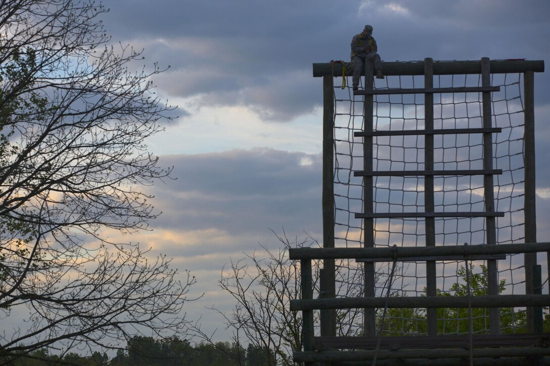 A soldier acts as a safety on the rope ladder obstacle course during the Ordnance Group Team of the Year 2016 competition at the Wendell H. Ford Regional Training Center in Greenville, Ky., April 25, 2016. Army photo by Pfc. Aaron Bratcher
