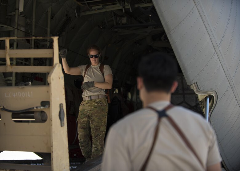 Senior Airman Jessica Jones, 774th Expeditionary Airlift Squadron loadmaster, directs a forklift to lower cargo onto the ramp of a C-130J Super Hercules at Bagram Airfield, Afghanistan, April 29, 2016. Aircraft loadmasters are responsible for properly loading, securing and escorting cargo and passengers, and ensuring the plane is properly balanced with the weight of the cargo evenly distributed. (U.S. Air Force photo by Senior Airman Justyn M. Freeman)