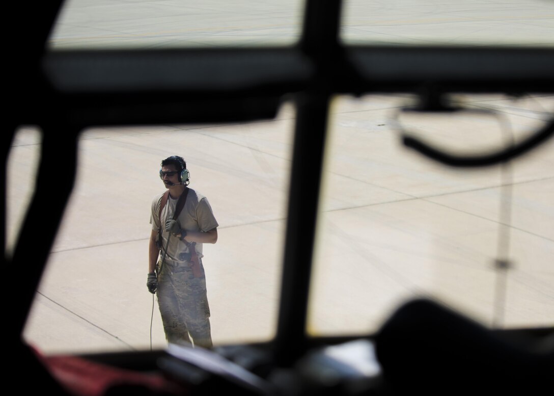 Senior Airman Chris Arnold, 774th Expeditionary Airlift Squadron loadmaster, ensures the propellers are functioning properly during a pre-flight inspection of a C-130J Super Hercules at Bagram Airfield, Afghanistan, April 29, 2016. Loadmasters ensure cargo and personell are loaded properly for flight. (U.S. Air Force photo by Senior Airman Justyn M. Freeman)