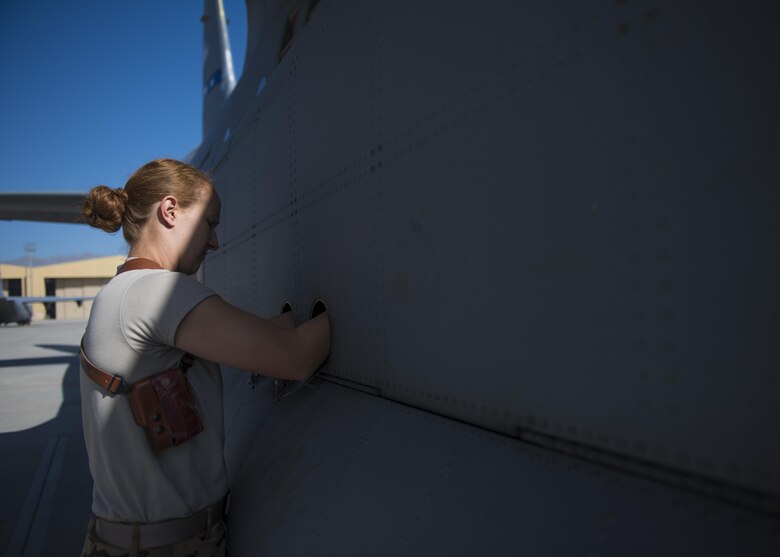 Senior Airman Jessica Jones, 774th Expeditionary Airlift Squadron loadmaster, locks the landing gear cover into place during a pre-flight inspection of a C-130J Super Hercules at Bagram Airfield, Afghanistan, April 29, 2016. Aircraft loadmasters are responsible for properly loading, securing and escorting cargo and passengers, and ensuring the plane is properly balanced with the weight of the cargo evenly distributed. (U.S. Air Force photo by Senior Airman Justyn M. Freeman)