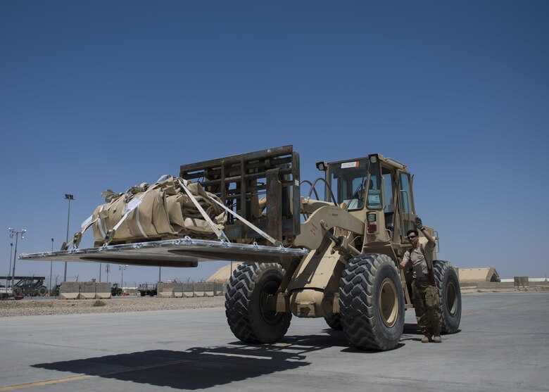 Senior Airman Chris Arnold, 774th Expeditionary Airlift Squadron loadmaster, directs a forklift with cargo to be loaded onto a C-130J Super Hercules at Bagram Airfield, Afghanistan, April 29, 2016. Members of the 774th EAS deliver cargo throughout Afghanistan to other forward operating bases. (U.S. Air Force photo by Senior Airman Justyn M. Freeman)
