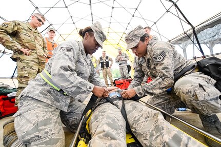 U.S. Air Force Senior Airman Jaquaisia Johnson, left, and Staff Sgt. Ivon Palacios-Araujo, right, 116th Medical Group, Detachment 1, Georgia Air National Guard, strap simulated patient, Airman 1st Class Kayla Martin, into the Stokes Basket rescue stretcher during the pre-EXEVAL Exercise Operation Nuclear Tide Hazard at Fort McClellan, Alabama, April 18, 2016. The diverse makeup of the National Guard is one of its strengths, senior leaders say.