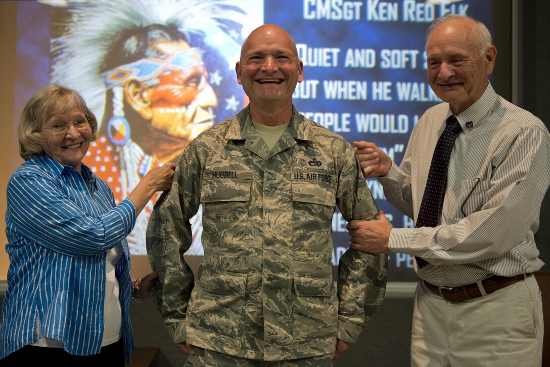 Chief Master Sgt. Carl T. Hubbell, 434th Logistics Readiness Squadron, has his new rank “tacked on” by his parents, Carl D. and Jackie Hubbell, during a noncommissioned officer induction ceremony April 10, 2016 at Grissom Air Reserve Base, Ind. During the ceremony 66 Airmen were inducted into the ranks of noncommissioned officers and senior noncommissioned officers. (U.S. Air Force Photo/Senior Airman Dakota Bergl)