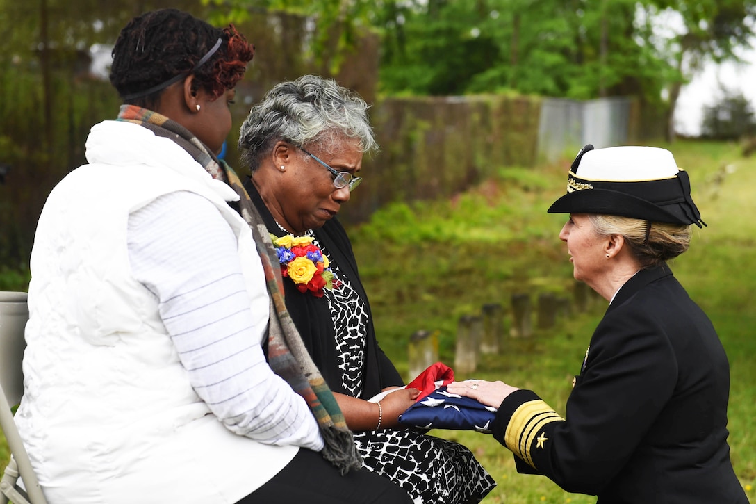 Chief of Navy Reserve Vice Adm. Robin Braun presents a U.S. flag to Bernadette Maybelle Parks Ricks, great-granddaughter of Medal of Honor recipient Joseph B. Noil, during a ceremony at St. Elizabeths Hospital cemetery in Washington, D.C., April 29, 2016. Noil received the Medal of Honor for actions while serving on the USS Powhatan in 1872, but his headstone did not recognize his award due to a misprint on his death certificate. Navy photo by Petty Officer 2nd Class Eric Lockwood
