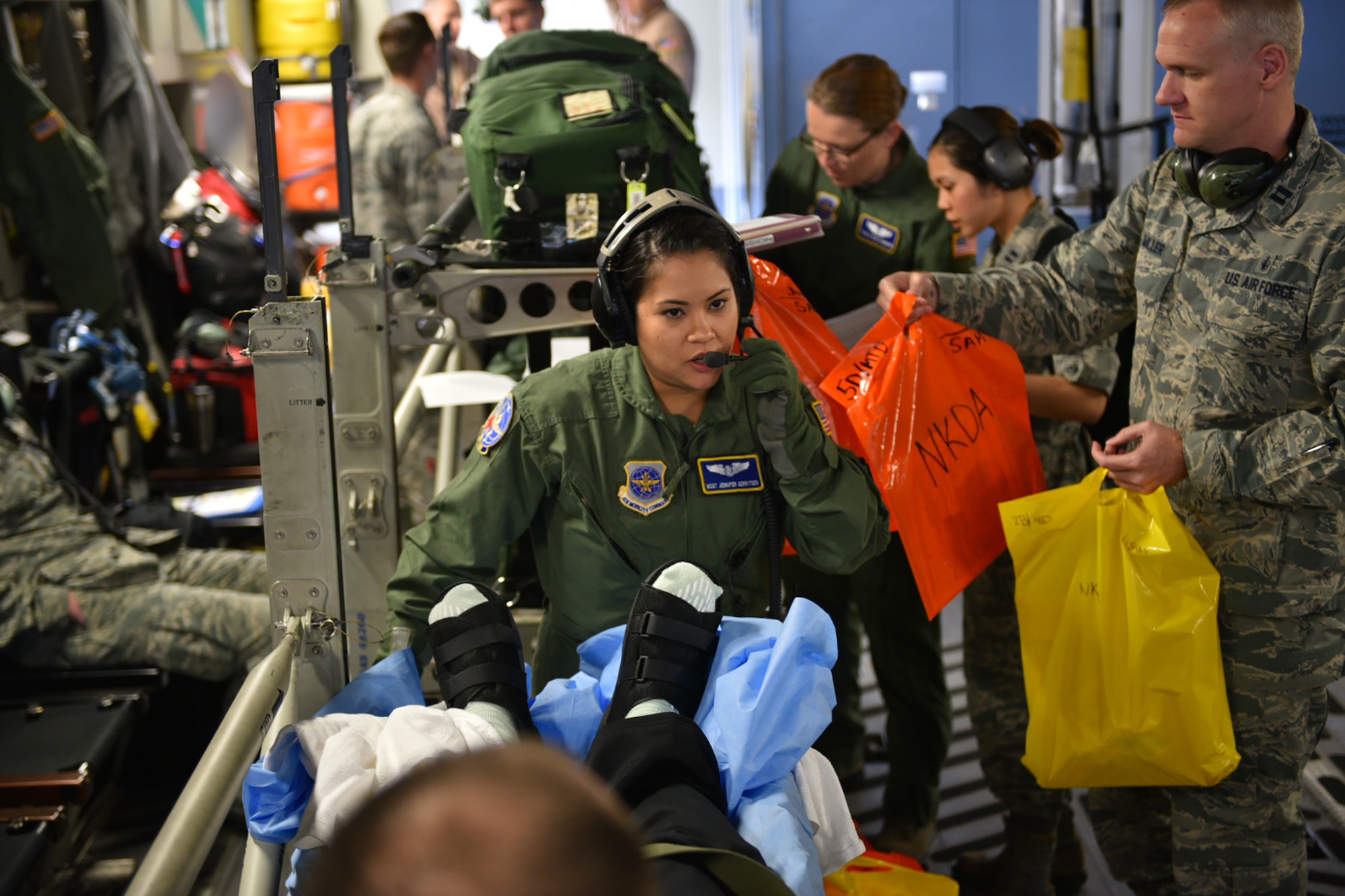 Master Sgt. Jennifer Gerritsen, an aeromedical technician with the 445th Aeromedical Evacuation Squadron, Wright-Patterson Air Force Base, Ohio, helps provide care for wounded warriors while deployed here April 21, 2016. Jennifer and her husband, Kiley, also assigned to the 445th AES, had the opportunity to serve together on this flight as they usually serve on separate crews tasked to rotate moving medical patients from down range to Germany and/or back to the United States. Even though they are on separate crews, their paths often cross as crews help others with preparing the aircraft and loading patients before going off on missions. (U.S. Air Force photo/Tech. Sgt. Frank Oliver)