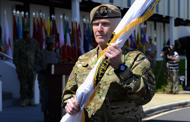 Army Gen. Raymond “Tony” Thomas, holds the guidon after assuming command of USSOCOM Mar. 30, 2016, at MacDill Air Force Base, Fla. The former Commander, Army Gen. Joseph L. Votel, will become the commander of U.S. Central Command. (Courtesy photo)
