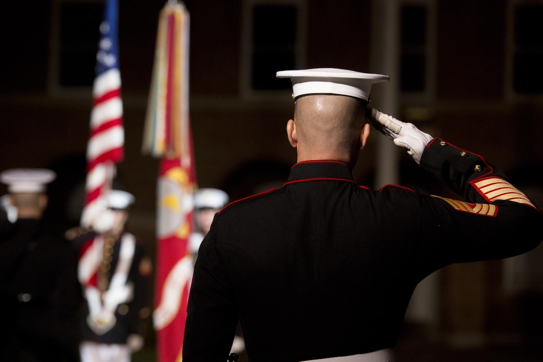1st Sgt. Michael Brown salutes during the presentation of the colors at the Friends and Family Evening Parade, Marine Barracks Washington, D.C., April 29, 2016. The guest of honor for the evening was Gen. Robert Neller, commandant of the Marine Corps, and the hosting official was Col. Benjamin T. Watson, commanding officer, MBW. (Official Marine Corps photo by Cpl. Chi Nguyen/Released)