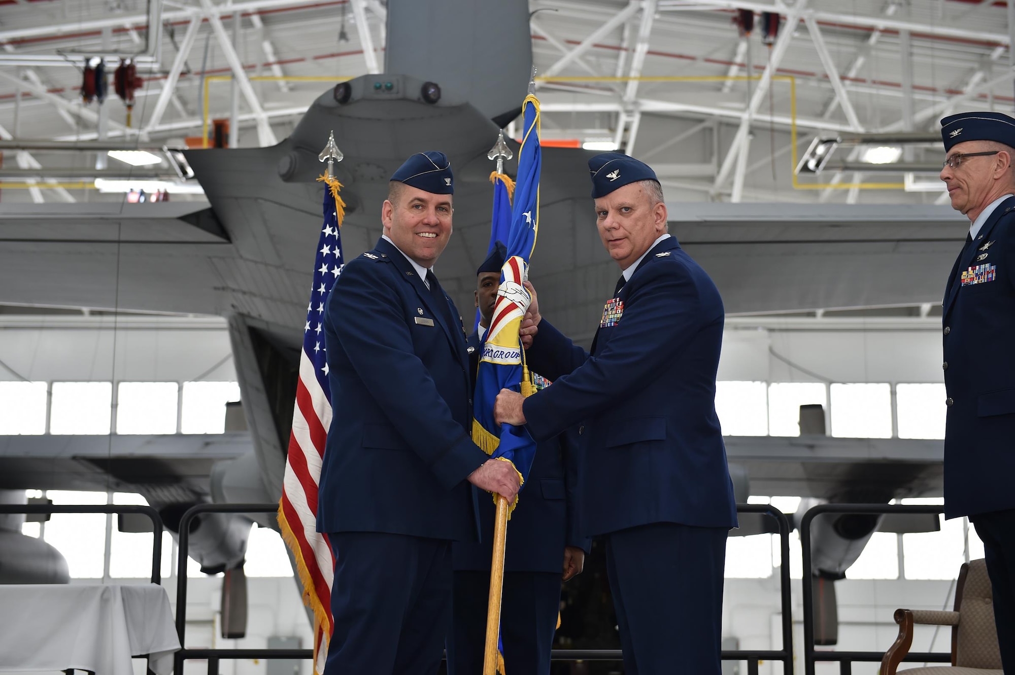 Col. James Dignan, 910th Airlift Wing commander, passes the 910th Mission Support Group flag to incoming commander, Col. Donald Wren, here, April 3, 2016. Wren replaced Col. Kevin Riley who retired after 31 years of service. (U.S. Air Force photo/Tech. Sgt. Rick Lisum)