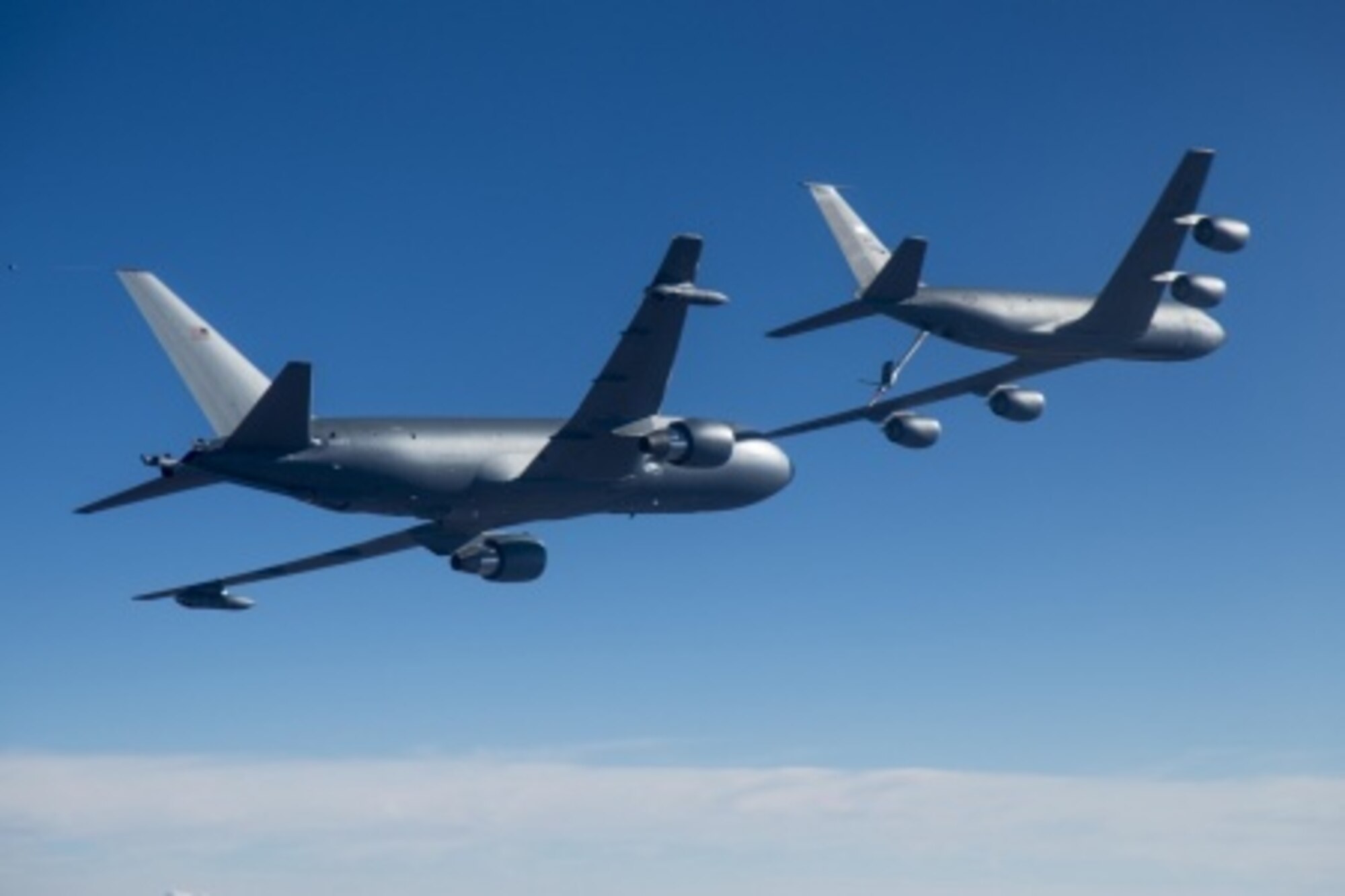 The KC-46A program's first test aircraft, EMD-1, conducts tests of aircraft acceleration and vibration exposure while flying in receiver formation at various speeds and altitudes behind the KC-135 Stratotanker. (U.S. Navy photo/Petty Officer 1st Class Christopher Okula)
