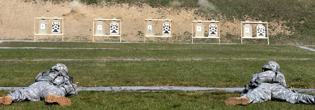 Two soldiers fire M16 rifles from the prone supported position during the weapons qualification event of the Best Warrior Competition at Camp Smith Training Site near Peekskill, N.Y., April 21, 2016. New York National Guard photo by Army Sgt. Michael Davis