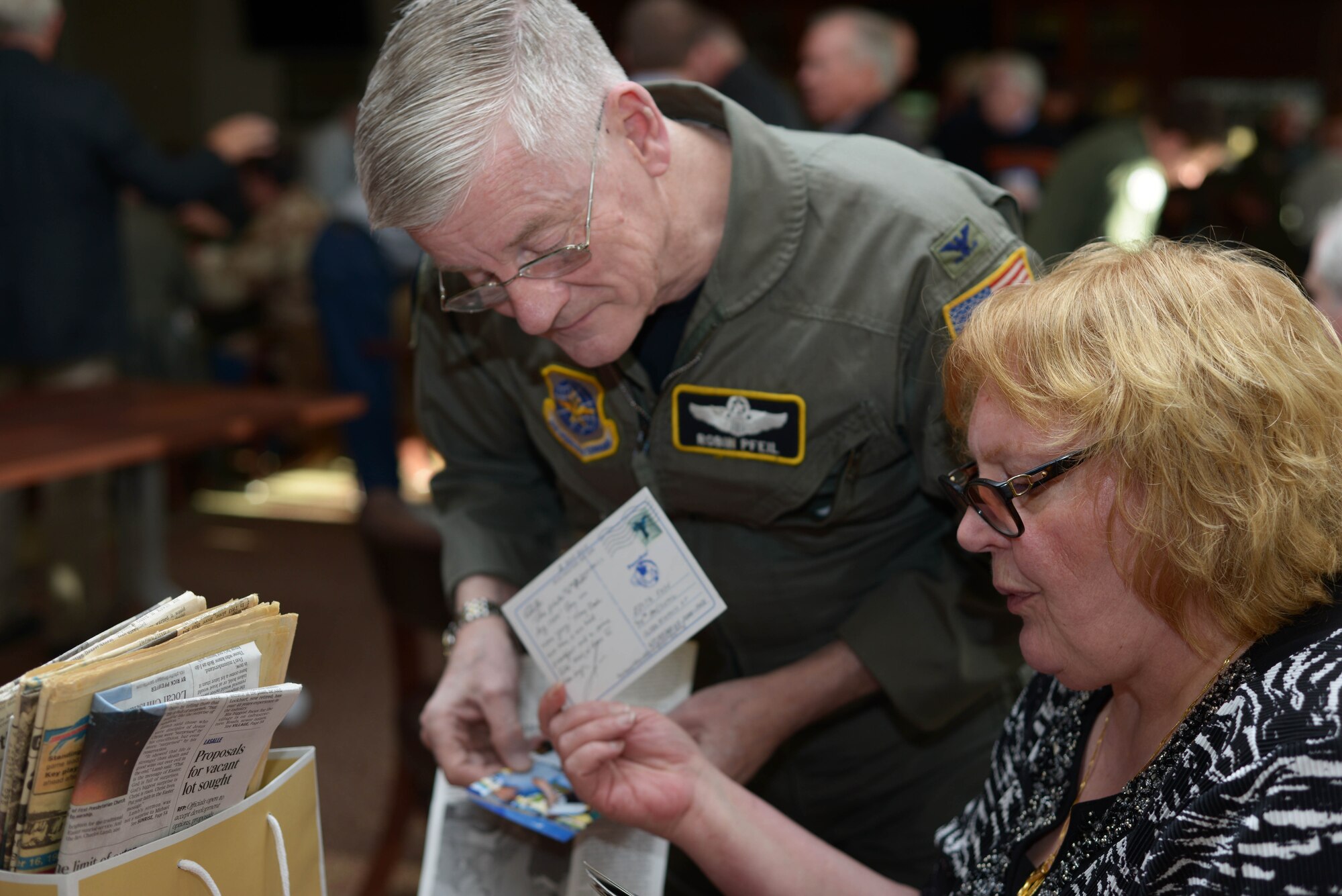 Col. (retired) Robin Pfeil, 914 Airlift Wing, former Vice Commander, and Edith Fose, General Manager, base lodging, look through old post cards and photos during the Desert Storm 25th Anniversary reunion, April 9, 2016, Niagara Falls Air Reserve Station. (U.S. Air Force photo by Staff Sgt. Richard D. Mekkri) 