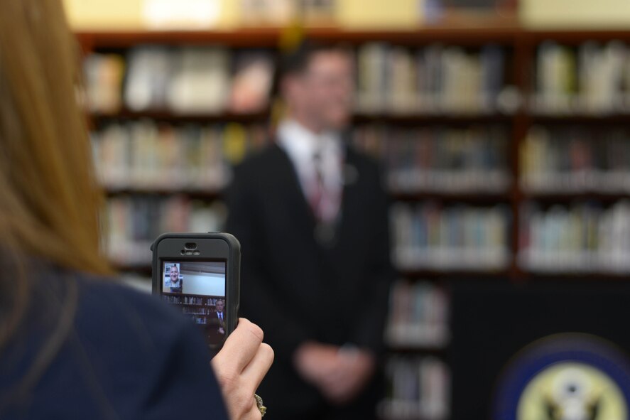 Master Sgt. Paul Curcione watches his son, Gabriel, receive the Congressional Silver Medal via a video conferencing app. Friday, April 22, 2016 at Wilson High School, Wilson, New York. Curcione is currently serving his annual tour in Kadena Air Base in Japan. (U.S. Air Force photo by Staff Sgt. Richard Mekkri)