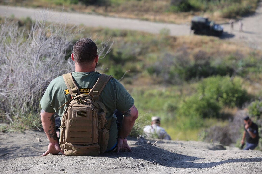 MARINE CORPS BASE CAMP PENDLETON, Calif. – Lance Cpl. Eddie Palos encourages fellow Marines up First Sergeant’s Hill during the 3rd Battalion, 5th Marine Regiment “Dark Horse” Reunion at the San Mateo Memorial Garden April 29, 2016. Palos served as a rifleman with Company I during the battalion’s deployment to Sangin, Afghanistan in the fall of 2010. (U.S. Marine Corps photo by Lance Cpl. Shellie Hall/Released)