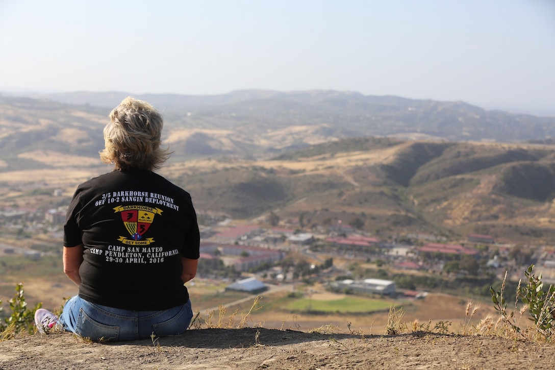 MARINE CORPS BASE CAMP PENDLETON, Calif. – Kathy Sims gazes at San Mateo from the top of First Sergeant’s Hill while Marines honor their fellow comrades during the Dark Horse Reunion at Camp Pendleton April 29, 2016. Sims is the 3rd Battalion, 5th Marine Regiment “Dark Horse” Reunion organizer. (U.S. Marine Corps photo by Lance Cpl. Shellie Hall/Released)