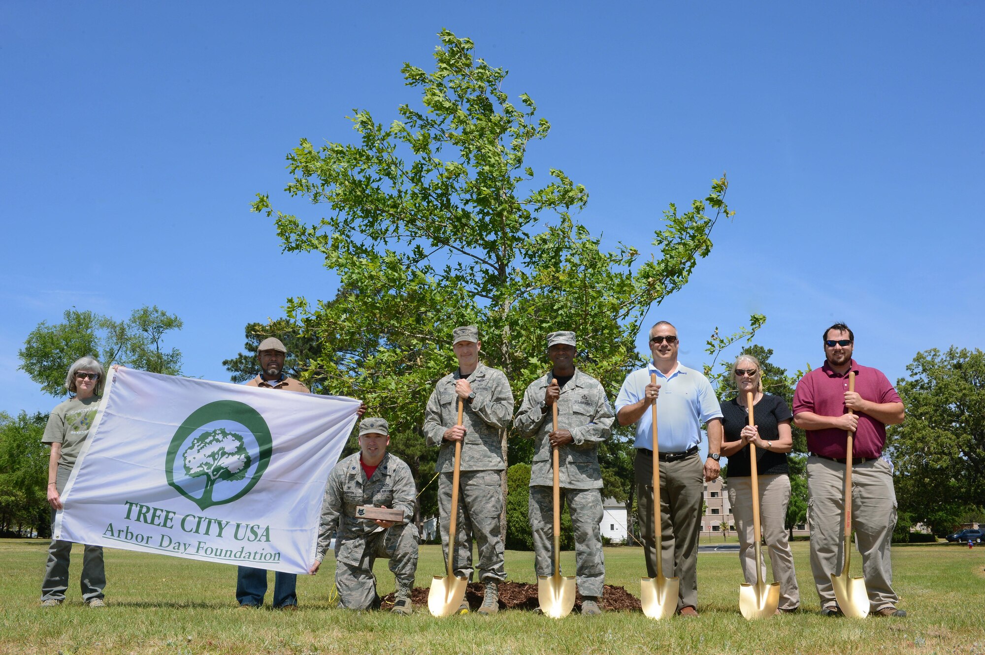 Representatives from the South Carolina Forestry Commission, 20th Fighter Wing leadership, and 20th Civil Engineer Squadron personnel stand in front of a newly-planted Overcup Oak tree on Arbor Day, April 29, 2016, at Shaw Air Force Base, S.C. By holding an annual Arbor Day observance, maintaining a forestry department and tree care ordinance, and spending more than $2 per capita on trees, Shaw has earned “Tree City, USA” status from the Arbor Day Foundation for the past 18 years. (U.S. Air Force photo by Senior Airman Zade Vadnais)

