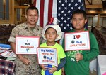 Defense Supply Center Richmond's annual "Bring Your Daughters and Sons to Work Day" was held April 28, 2016, in the Frank B. Lotts Conference Center in Richmond, Virginia. During the activities, Defense Logistics Agency Aviation Senior Enlisted Advisor Marine Master Gunnery Sgt. Phu Cao and his sons Huy, center, and Trung, right, share positive messages. The event, titled "Sparkling Aha! Moments,” was open to children ages 8-19, and over 160 children participated. 