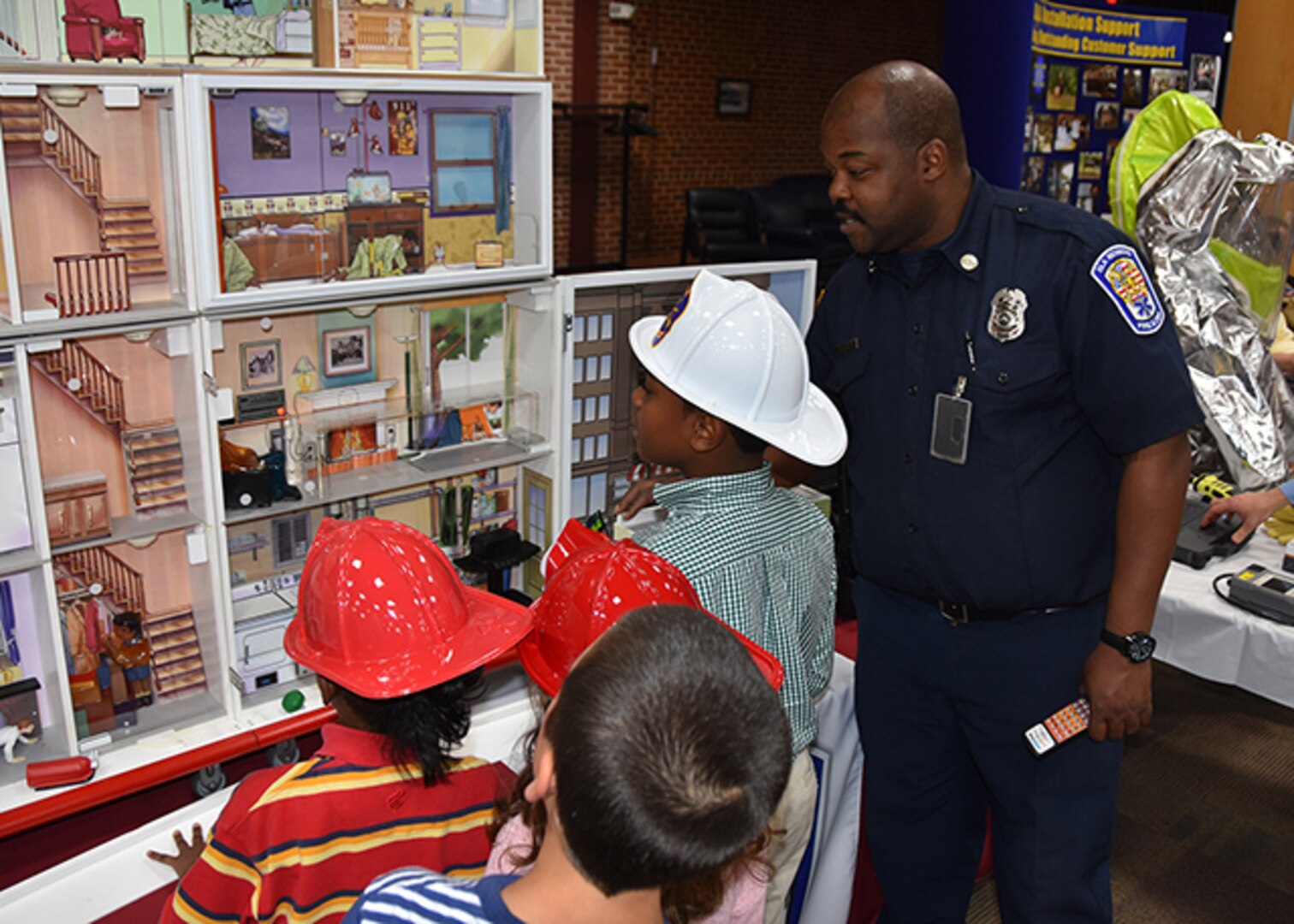 Defense Logistics Agency Installation Support at Richmond's Fire Inspector Evron Brightly explains home fire safety to children attending "Bring Your Daughters and Sons to Work Day," April 28, 2016 in the Frank B. Lotts Conference Center in Richmond, Virginia. This year’s event titled, "Sparkling Aha! Moments," was open to children ages 8-19, and over 160 children participated.   
