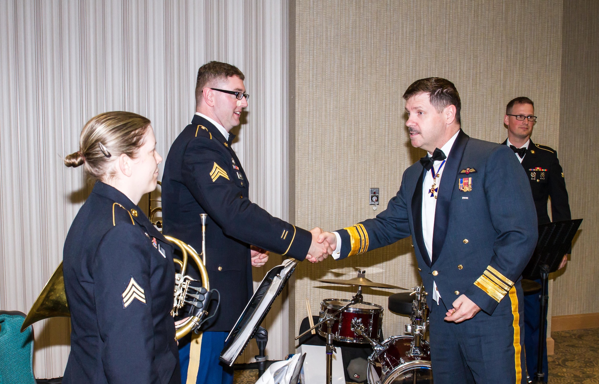Lt. Gen. Pierre St. Amand, deputy commander for North American Aerospace Defense Command (NORAD), shows his appreciation to the Army’s I Corps Band for providing entertainment during the Canadian Mess Dinner April 15 at the American Lake Conference Center, Joint Base Lewis-McChord. (Courtesy photo by Conrad Neumann II)