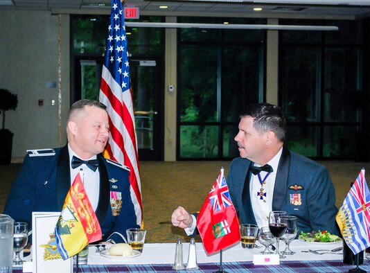 Lt. Gen. Pierre St. Amand, deputy commander for North American Aerospace Defense Command (NORAD), speaks with Col. Gregor Leist, Western Air Defense Sector commander, during the Canadian Mess Dinner April 15 at the American Lake Conference Center at Joint Base Lewis-McChord. (U.S. Air National Guard photo by Capt. Kimberly Burke)