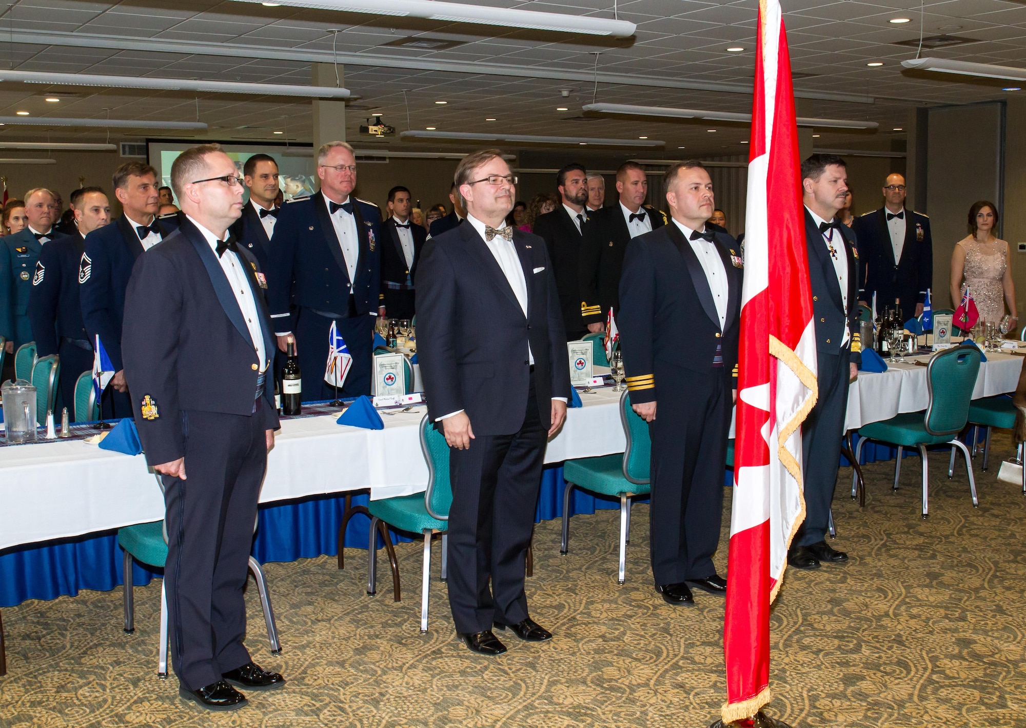 Members of the head table stand for the playing of the Canadian national anthem during the 92nd Anniversary of the Royal Canadian Air Force (RCAF) Mess dinner hosted by the Western Air Defense Sector Canadian Detachment April 15 at the American Lake Conference Center, Joint Base Lewis-McChord.  Pictured from left to right: Canadian Air Force Chief Warrant Officer Marc Corriveau; Michael Wooff, consul to the Canadian Consulate; Lt. Col. Matthew Wappler, Canadian Detachment commander; and Lt. Gen. Pierre St. Amand, deputy commander for North American Aerospace Defense Command. (Courtesy photo by Conrad Neumann II)