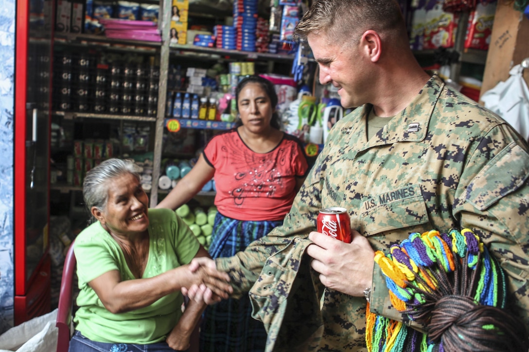 Marine Corps Capt. James Atkinson greets a resident before an upcoming Medical Readiness Exercise in La Blanca, Guatemala, April 29, 2016. Task Force Red Wolf and Army South conducted civil assistance training with Guatemalan government and nongovernment agencies to improve the mission readiness of U.S. forces and provide a lasting benefit to the Guatemalan people. Army photo by Spc. Glenaj Washington