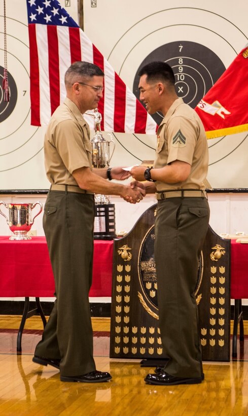 Cpl. Alvin H. Mei, an electro-optical ordnance repairman with Headquarters and Services Company, 2nd Battalion, 23rd Marine Regiment, 4th Marine Division, Marine Forces Reserve, receives a gold medal during the 2016 Marine Corps Rifle and Pistol Matches Award Ceremony on Marine Corps Base Camp Lejeune, N.C., April 22, 2016. The Marine Corps Rifle and Pistol Matches Award Ceremony marks the end of the annual Marine Corps Competition-in-Arms program. The Competition-in-Arms program has provided Marines around the world with the opportunity to achieve various medals and trophies by displaying their skill in small arms marksmanship. (U.S. Marine Corps photo by Lance Cpl. Kimberly Aguirre/Released)