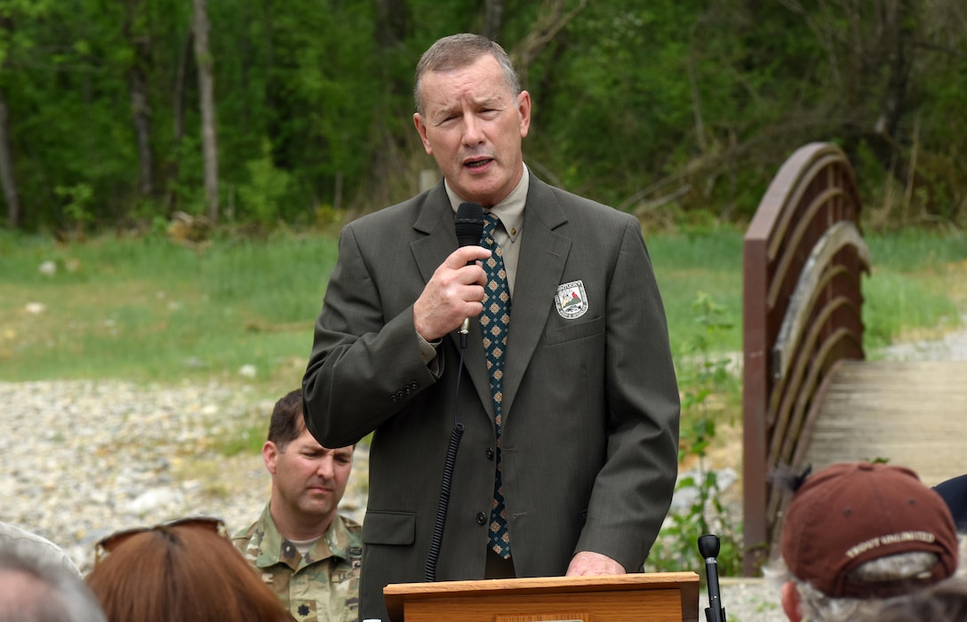 Gregory K. Johnson, Kentucky Department of Fish and Wildlife Resources commissioner, talks about the benefit of Hatchery Creek during a dedication ceremony for the stream below Wolf Creek Dam in Jamestown, Ky., April 29, 2016.  Hatchery Creek extends more than a mile through woodlands and wetlands with man-made runs, glides, pools, eddies, shoals and hunker bunkers cut up under its banks to mimic natural, wild streams and encourage natural behavior and spawning of wild trout.