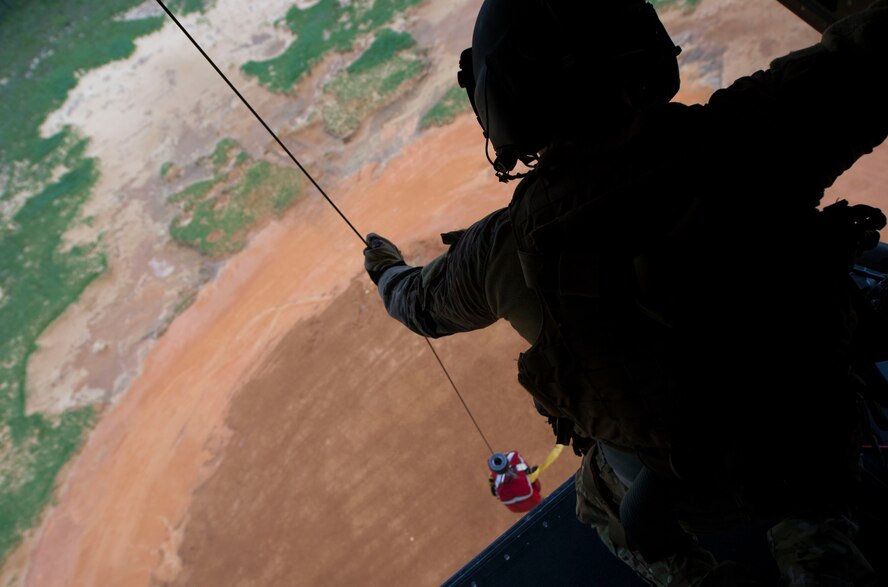 Staff Sgt. Michael Rossi, a flight engineer with the 8th Special Operations Squadron, practices rescue missions on a CV-22 Osprey during a training flight at Hurlburt Field, Fla., April 27, 2016. The Osprey is a multi-mission tilt-rotor aircraft with vertical take-off and landing capability. (U.S. Air Force photo by Senior Airman Krystal M. Garrett)