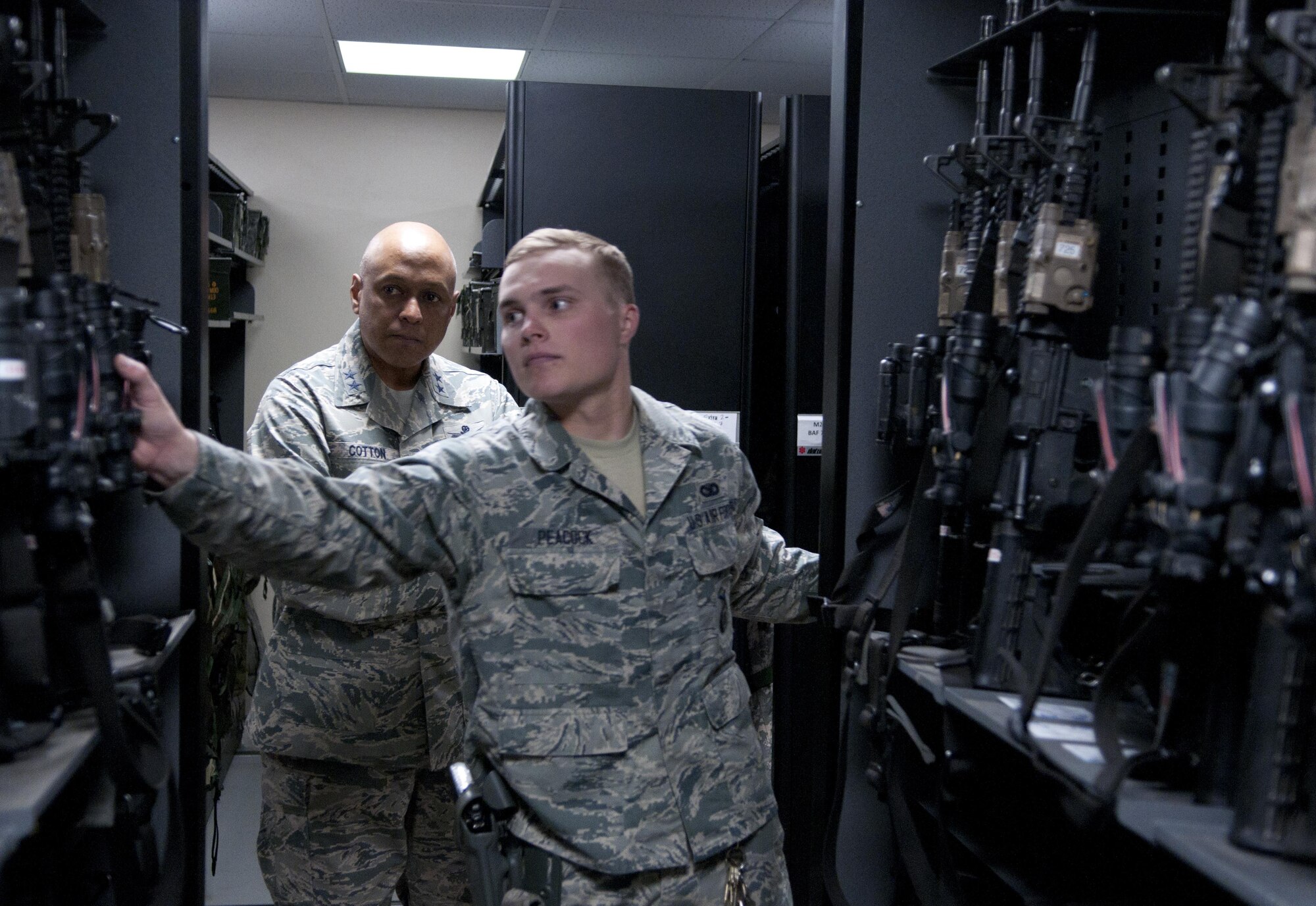 Airman 1st Class Brent Peacock, 90th Security Support Squadron member, guides Maj. Gen. Anthony Cotton, 20th Air Force and Task Force 214 commander, through the 90th Security Forces Group Armory, April 28, 2016, on F.E. Warren Air Force Base, Wyo. At each stop during Cotton’s visit he asked the Airmen if there was anything they would change if they could; many provided a detailed answer. (U.S. Air Force photo by Airman 1st Class Malcolm Mayfield)