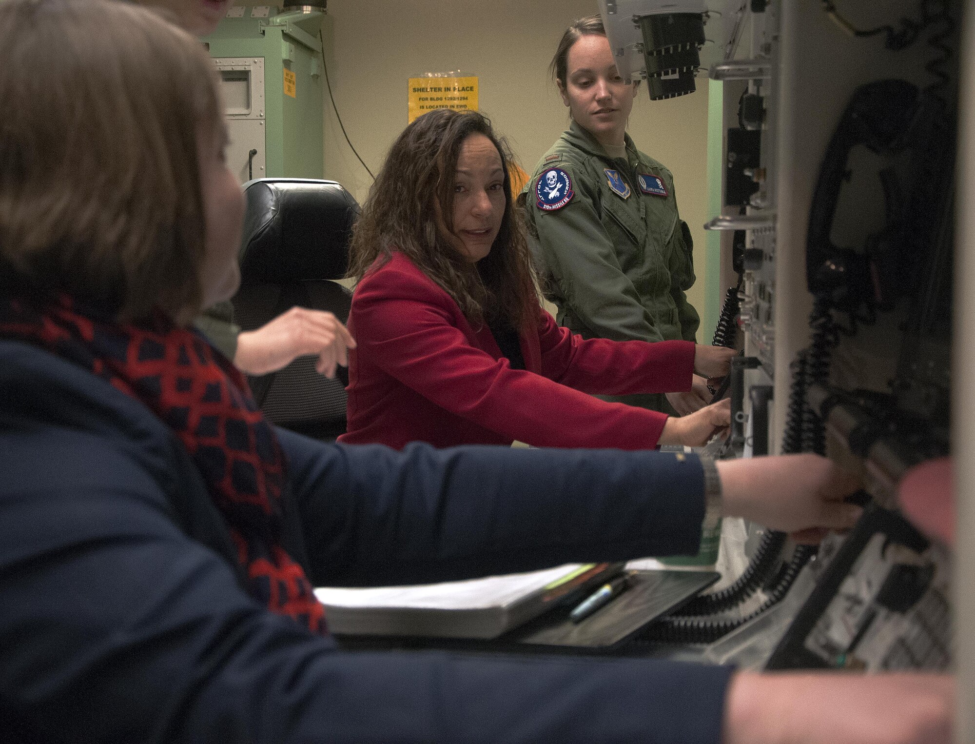 Marsha Cotton, wife of Maj. Gen. Anthony Cotton, 20th Air Force and Task Force 214 commander, and Suzanne Sauls, wife of Col. Todd Sauls, 90th Operations Group commander, perform a mock-key turn April 28, 2016, during a tour of the 90th Operations Support Squadron’s missile procedure trainer on F.E. Warren Air Force Base, Wyo. The MPT allows missileers to run through a number of potential situations that can arise when on alert. (U.S. Air Force photo by Senior Airman Brandon Valle)