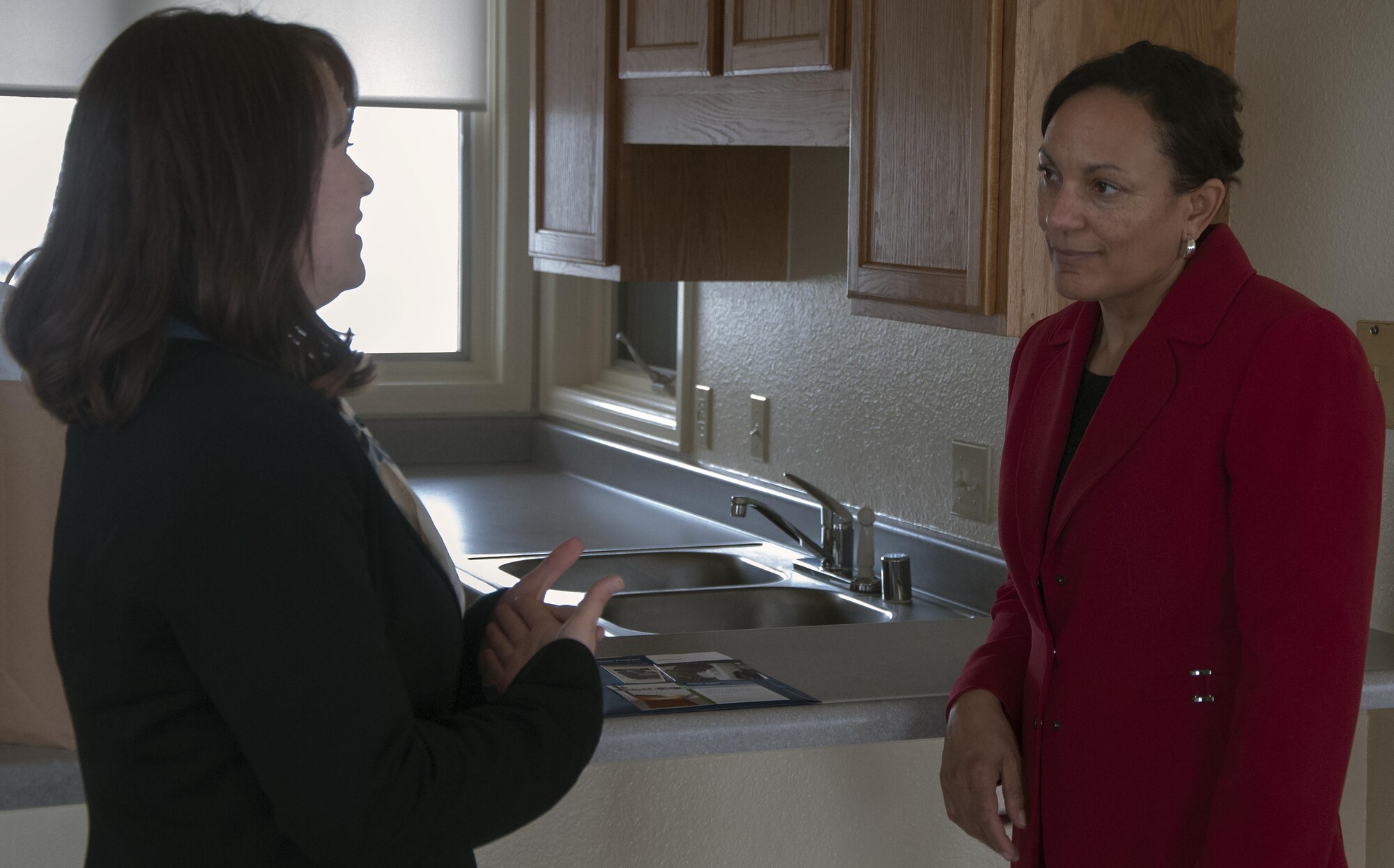 Melissa Johnson, left, Balfour Beatty Communities representative, talks to Marsha Cotton, wife of Maj. Gen. Anthony Cotton, 20th Air Force and Task Force 214 commander, about the on-base housing opportunities on F.E. Warren Air Force Base, Wyo., for Airmen and their families April 28, 2016. Cotton toured the dormitories and Airmen residents to learn about the available housing opportunities on base. (U.S. Air Force photo by Senior Airman Brandon Valle)