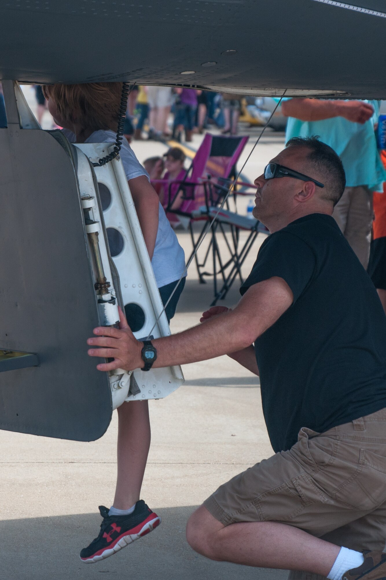 Clifford Brown helps a young air show spectator into the flight deck of a B-52 Stratofortress during the Defenders of Liberty Air Show at Barksdale Air Force Base, La on May 1, 2016. Brown is one of the volunteers of the U.S. Air Force Reserve 307th Bomb Wing that showcased the bombers during the air show. (U.S. Air Force photo by Master Sgt. Dachelle Melville/Released)