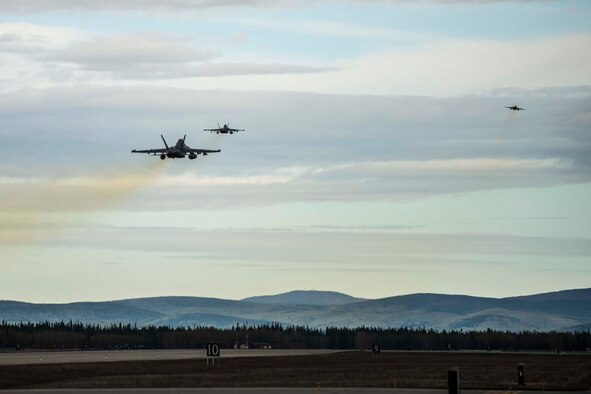 Three U.S. Navy EA-18G Growlers assigned to Electronic Attack Squadron 137, Naval Air Station Whidbey Island, Wa., takes off from Eielson Air Force Base, Alaska, May 2, 2016, during RED FLAG-Alaska (RF-A) 16-1. RF-A enables joint and international units to sharpen their combat skills by flying simulated combat sorties in a realistic threat environment. (U.S. Air Force photo by Staff Sgt. Joshua Turner/Released)