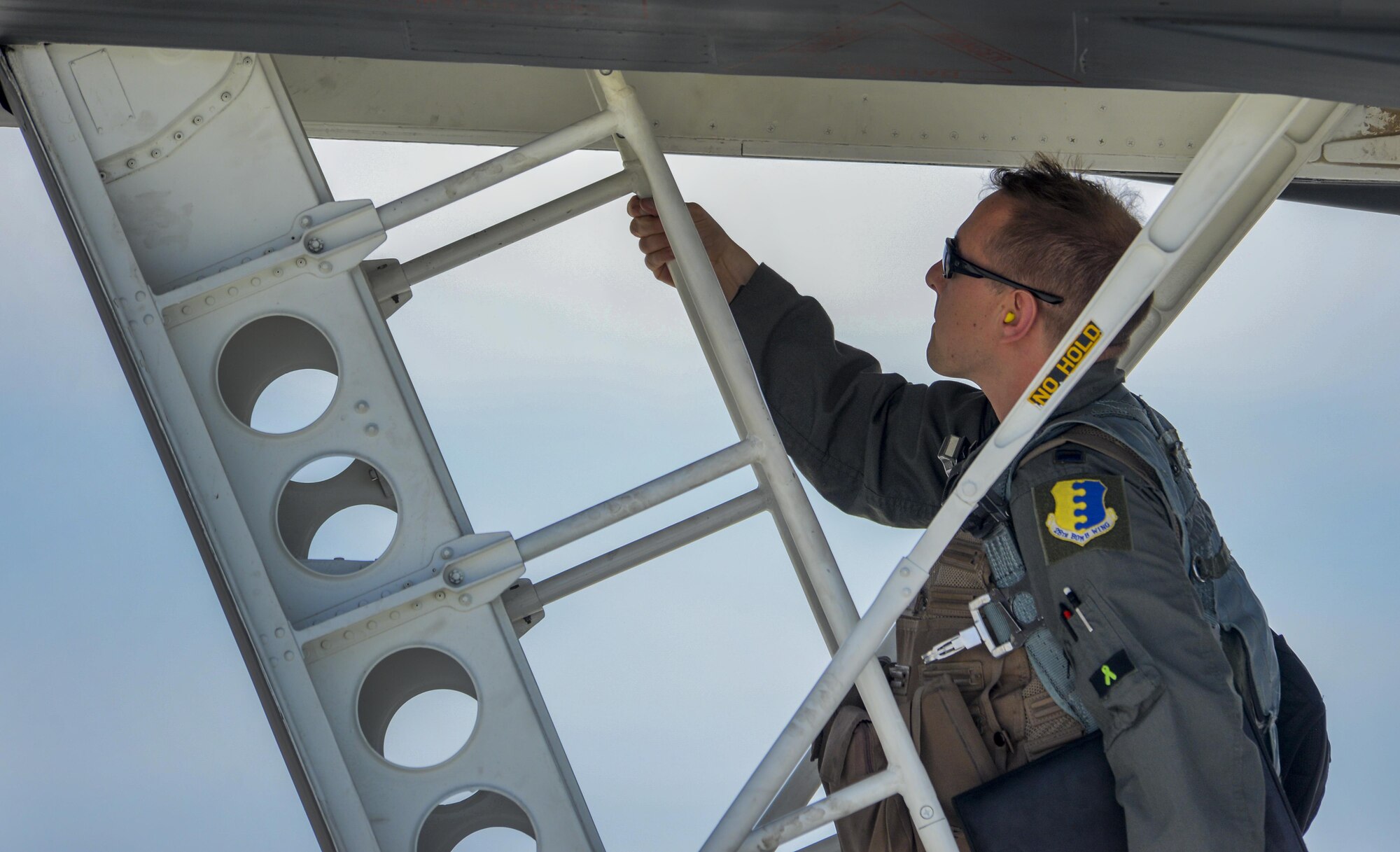 An Airman, assigned to the 34th Bomb Squadron, Ellsworth Air Force Base, S.D., climbs up ladder to a B-1B Lancer during Green Flag 16-05 at Nellis Air Force Base, Nev., April 21, 2016. During 2016 there will be nine iterations of the Green Flag Exercise. For organizations like the 34th Bomb Squadron from Ellsworth Air Force Base, South Dakota, the Green Flag air-to-ground exercise provides dynamic training for the Airmen from their B-1B Lancer aircrew and support personnel to prepare for deployments. (U.S. Air Force photo by Airman 1st Class Kevin Tanenbaum)