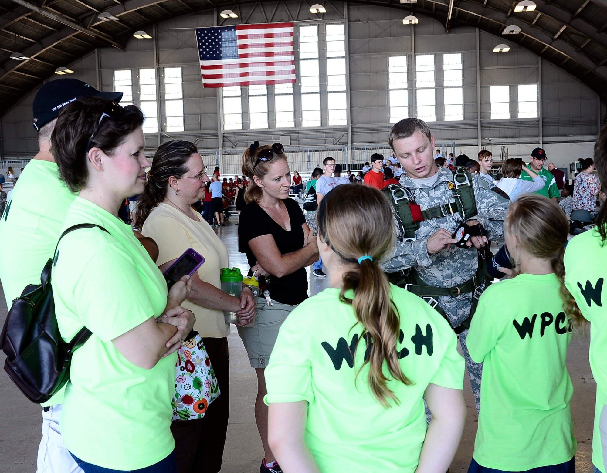 Army Staff Sgt. Charles Creech, a parachute rigger with the Joint Communications Support Element, shows students an MA 10 Altimeter which is used to measure altitude during School Day at MacDill Air Force Base, Fla., April 29, 2016. School Day included a military working dog demonstration along with various interactive displays from base agencies and science, technology, engineering and math students. (U.S. Air Force photo by Senior Airman Tori Schultz)