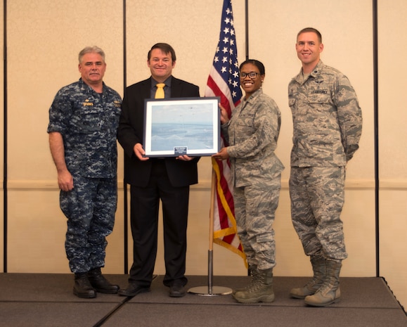 Jason Bowen (center), a Charleston County Sherriff’s Office Special Victims Unit detective, receives an award from (left to right) Capt. Timothy Sparks, Joint Base Charleston deputy commander, Capt. Sheontee Frank, 628 Medical Group Family Advocacy officer, and Lt. Col. Brian Neese, 628 Medical Operations Squadron commander, at the Child Abuse Prevention Luncheon April 26, 2016 at Joint Base Charleston.  April was declared Child Abuse Prevention Month by a presidential proclamation in 1983, since then April has been a time to encourage families and communities to prevent child abuse. (U.S. Air Force Photo/Airman Megan Munoz)