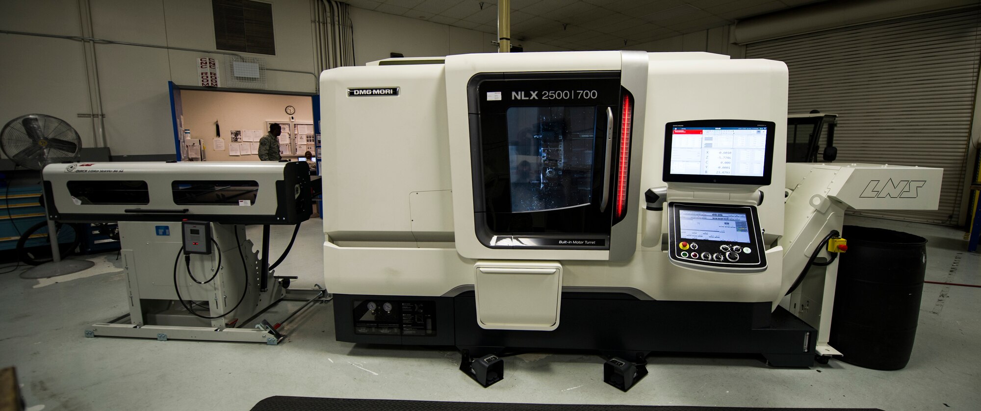 After one side of a part is finished the double spindle lathe (DMG NLX-2500/700 SY), will spin and work on the other side without an Airman having to manually reposition the part. The tools that are in the machine spin at up to 10,000 revolutions per minute in order for the machine to perform milling operations while the part is already spinning. (U.S. Air Force photo/Airman 1st Class Sean Campbell)