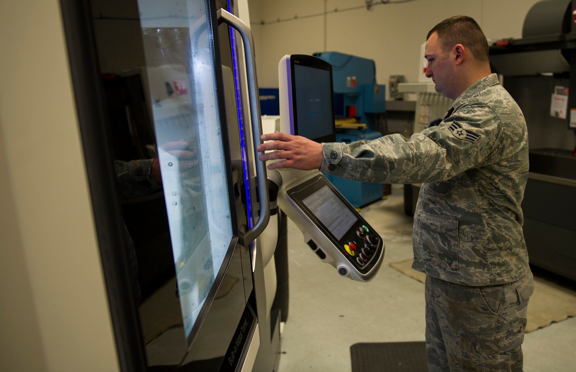 Senior Airman Shane Johnson, 92nd Maintenance Squadron metals technician, preps the DMG NLX-2500/700 SY for use April 18, 2016, at Fairchild Air Force Base, Wash. The main focus of Fairchild’s machine shop is to be able to manufacture any part that comes to this shop and have it produced in a timely manner. (U.S. Air Force photo/Airman 1st Class Sean Campbell)
