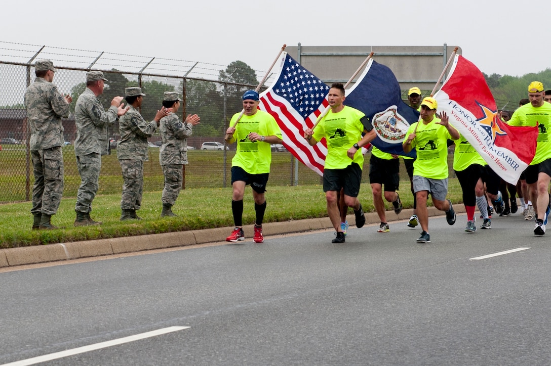 U.S. Airmen cheer on runners during the Virginia Run for the Fallen outside the Armistead Gate at Langley Air Force Base, Va., April 28, 2016. Each year, the run brings athletes and support crew members together to run one mile in honor of each Virginia Service member who died while serving during operations Iraqi Freedom, Enduring Freedom and New Dawn. (U.S. Air Force photo by Senior Airman R. Alex Durbin)