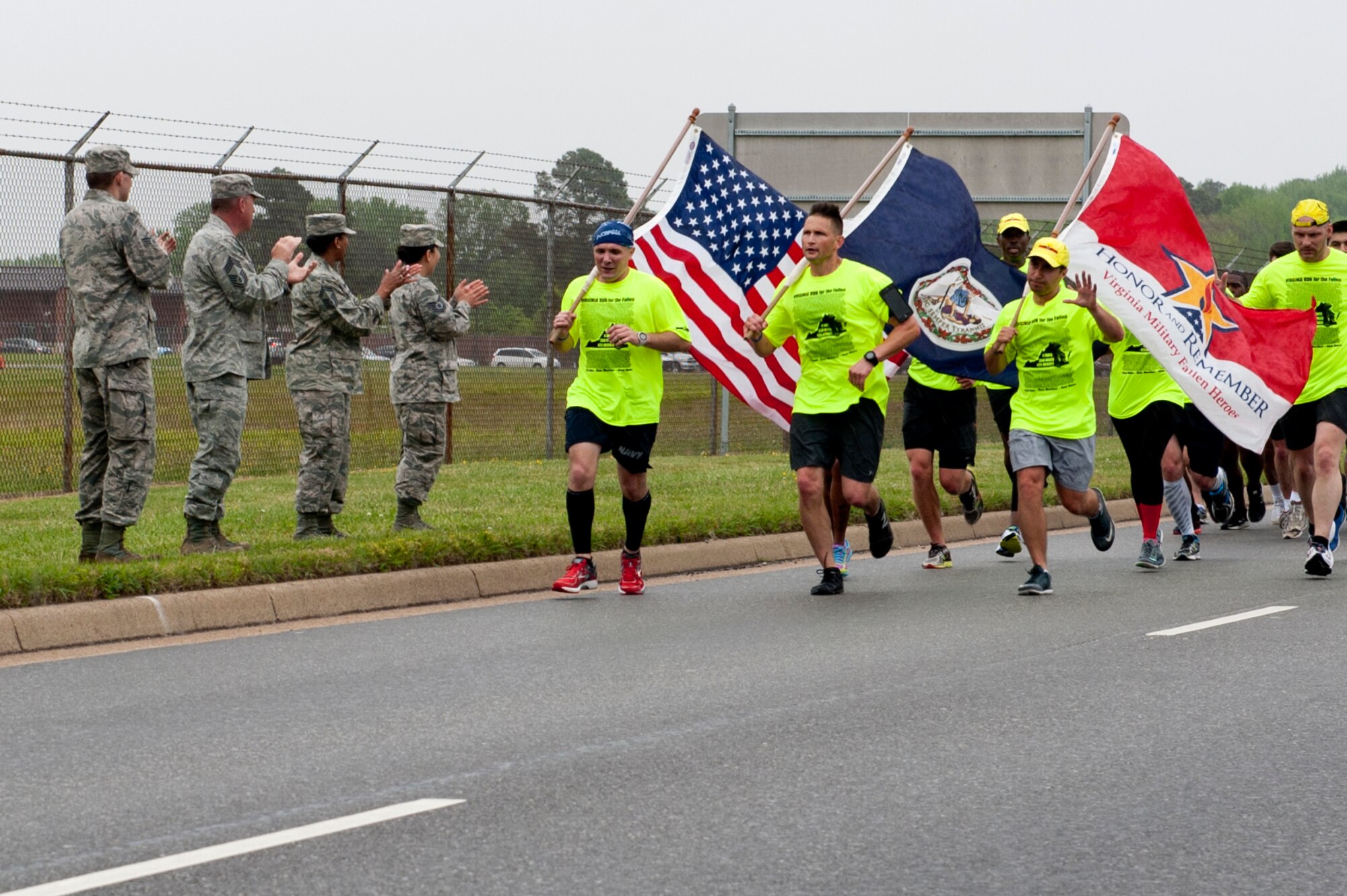 U.S. Airmen cheer on runners during the Virginia Run for the Fallen outside the Armistead Gate at Langley Air Force Base, Va., April 28, 2016. Each year, the run brings athletes and support crew members together to run one mile in honor of each Virginia Service member who died while serving during operations Iraqi Freedom, Enduring Freedom and New Dawn. (U.S. Air Force photo by Senior Airman R. Alex Durbin)
