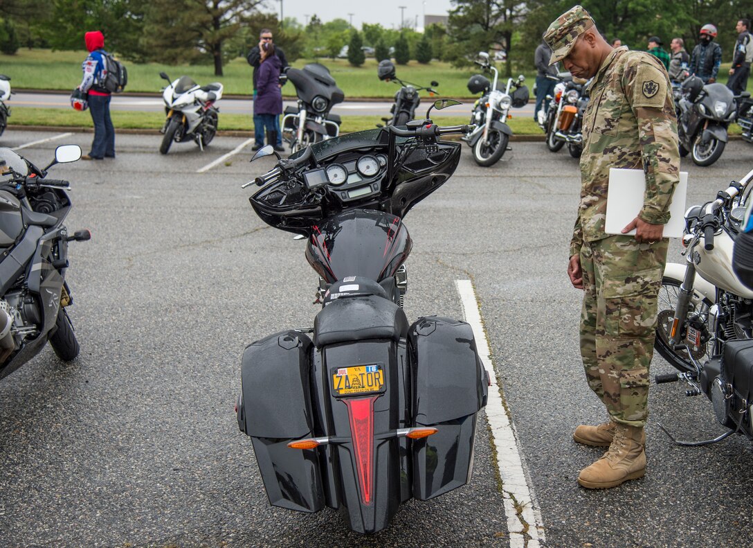 U.S. Army Col. Joseph E. Ladner, vice commander of the 633rd Air Base Wing, checks out a motorcycle during the 5th annual Standing Together Against Rape Road Rally at Langley Air Force Base, Va., April 29, 2016. The event aimed to increase awareness by standing together in an effort to eliminate sexual assault. (U.S. Air Force photo by Senior Airman Kayla Newman)